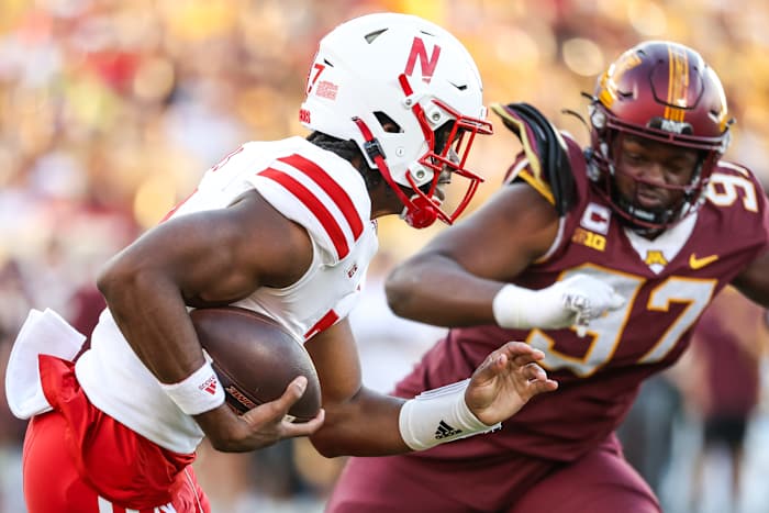 Nebraska quarterback Jeff Sims attempts to evade Gopher defensive lineman Jalen Logan-Redding.
